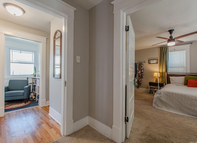 bedroom with ceiling fan and light hardwood / wood-style flooring