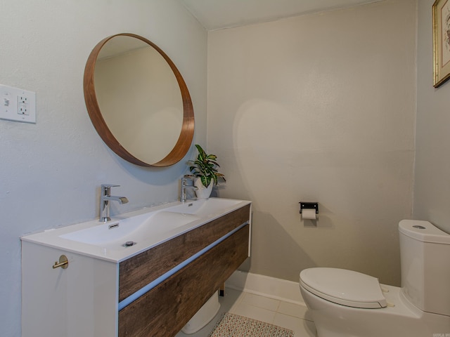 bathroom featuring vanity, toilet, and tile patterned flooring