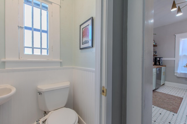 bathroom with toilet and tile patterned floors