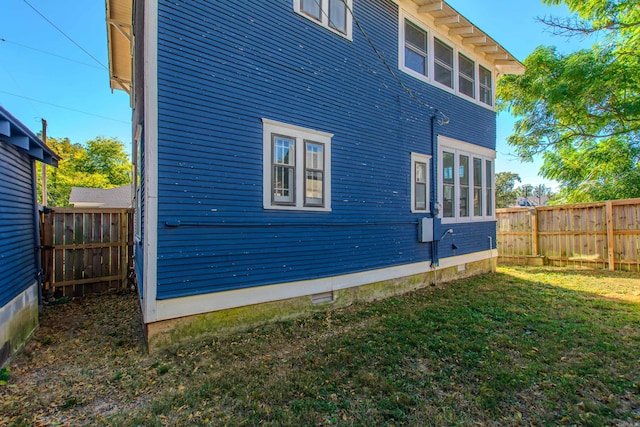 view of home's exterior with a lawn