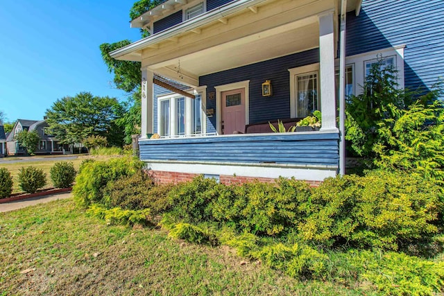 view of side of home with a porch