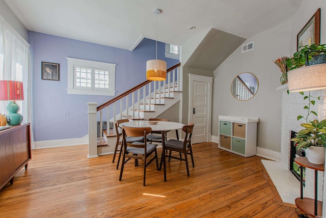 dining area featuring light hardwood / wood-style floors and a fireplace