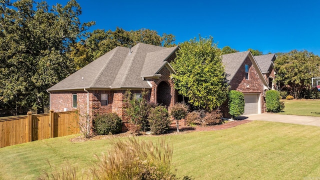 view of front of home with a front lawn and a garage