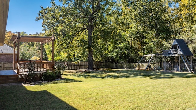 view of yard featuring a wooden deck and a playground