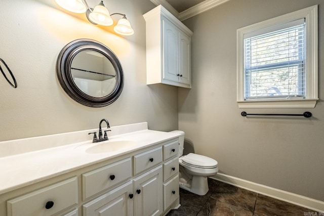 bathroom with vanity, ornamental molding, and toilet