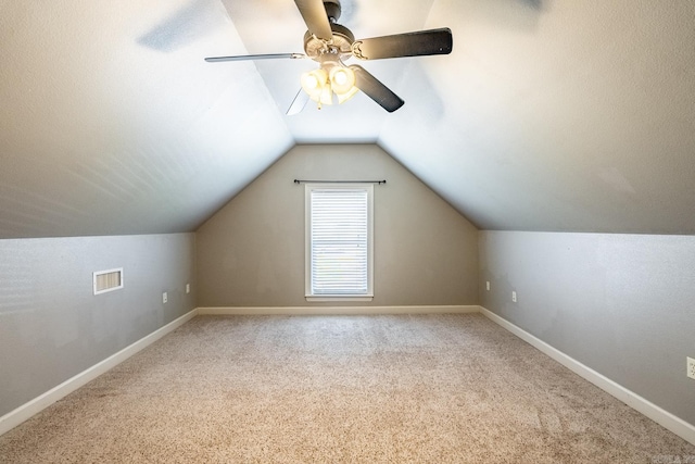 additional living space with ceiling fan, carpet, and vaulted ceiling