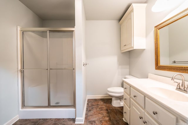 bathroom featuring vanity, toilet, and walk in shower