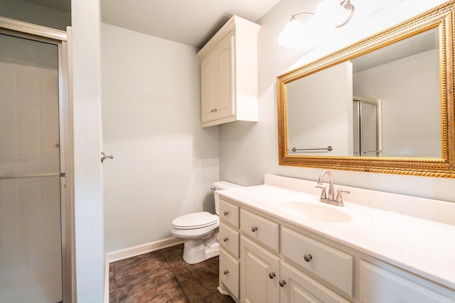 bathroom featuring vanity, toilet, and an enclosed shower