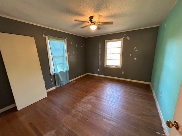 interior space featuring crown molding, a textured ceiling, dark wood-type flooring, and ceiling fan