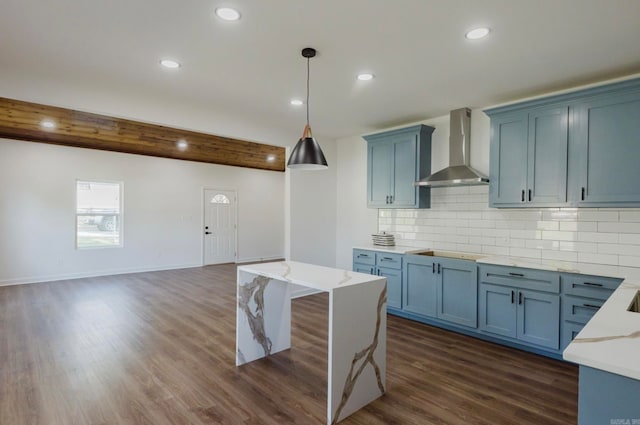 kitchen with dark wood-type flooring, wall chimney range hood, beamed ceiling, and decorative light fixtures