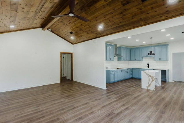 kitchen with hanging light fixtures, vaulted ceiling with beams, and dark hardwood / wood-style floors