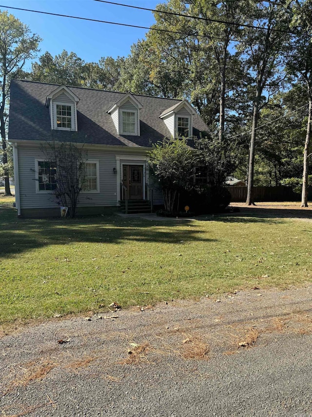 cape cod home with a front yard