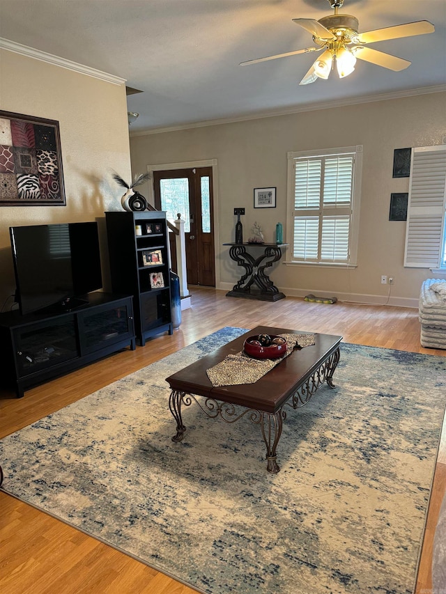 living room featuring ornamental molding, hardwood / wood-style flooring, and ceiling fan