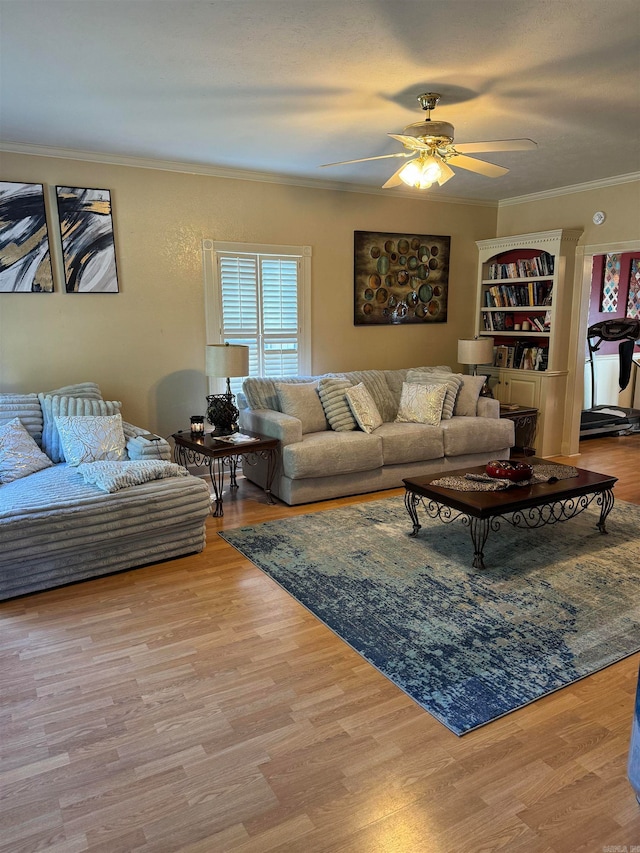 living room featuring ceiling fan, ornamental molding, and light hardwood / wood-style flooring