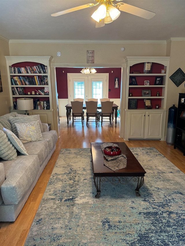 living room with light hardwood / wood-style floors, crown molding, french doors, and ceiling fan