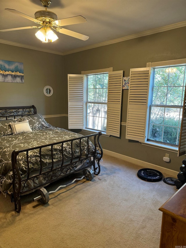 carpeted bedroom featuring ceiling fan, crown molding, and multiple windows