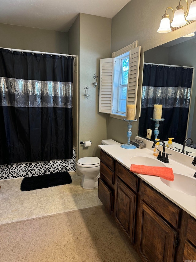 bathroom featuring vanity, toilet, and tile patterned floors