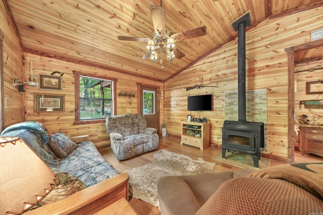 living room with wood walls, wood ceiling, a wood stove, vaulted ceiling, and hardwood / wood-style flooring