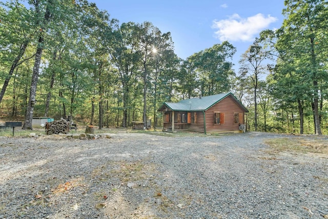 view of side of home featuring covered porch