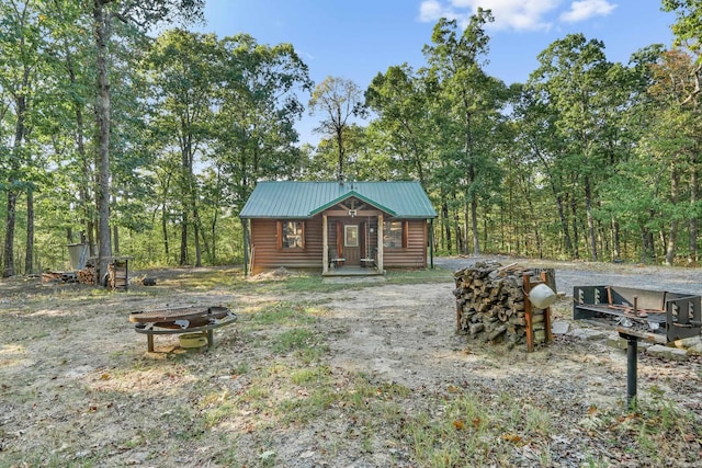 view of yard with an outdoor structure and a fire pit