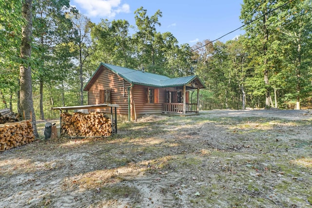 view of side of property featuring covered porch