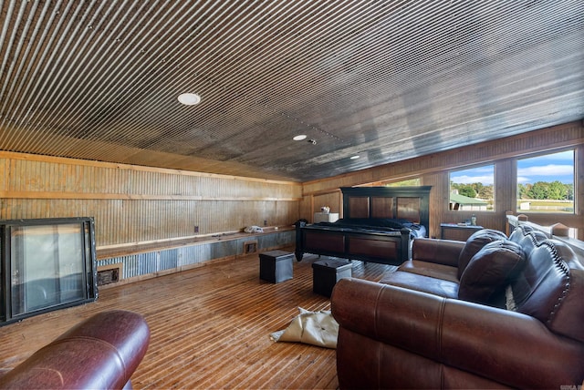 living room featuring wood ceiling and wooden walls