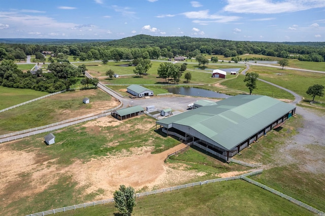 birds eye view of property featuring a water view and a rural view