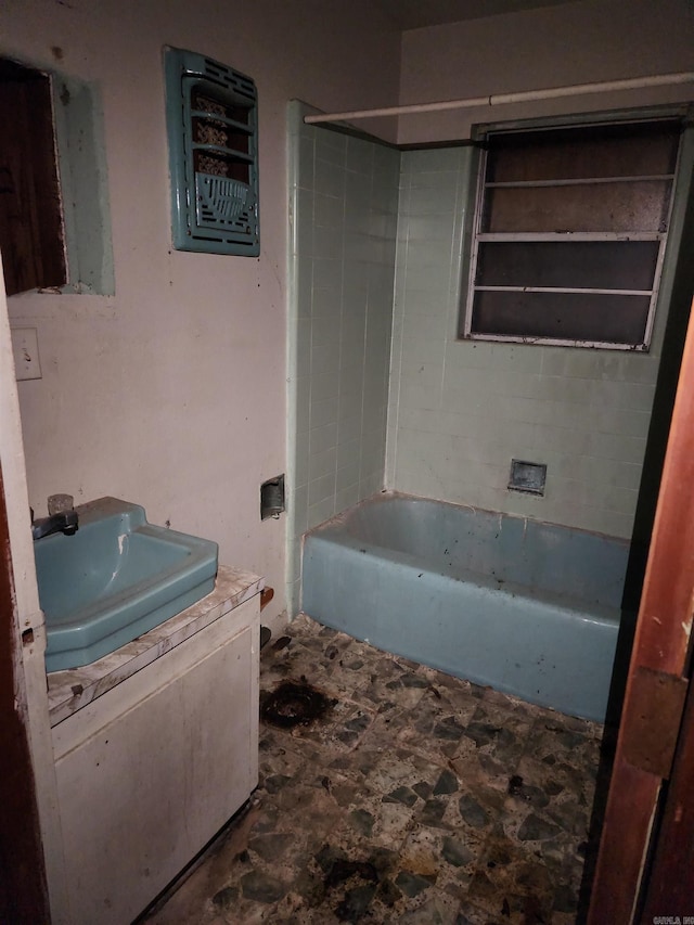 bathroom with vanity and tiled shower / bath combo