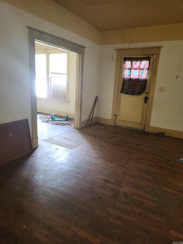 empty room with dark hardwood / wood-style flooring