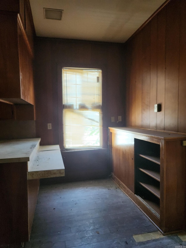 kitchen featuring dark hardwood / wood-style flooring and wooden walls