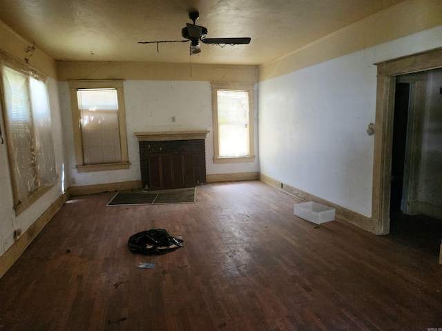 1706 S Laurel, Pine Bluff, AR 71603 - unfurnished living room with baseboards, a brick fireplace, wood finished floors, and ceiling fan