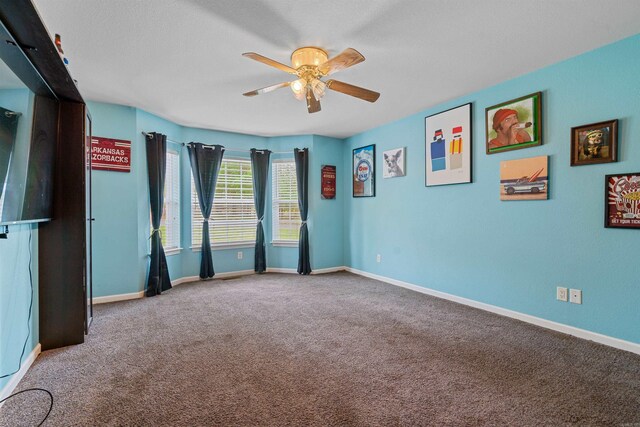 spare room with carpet floors and ceiling fan