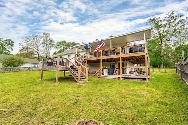 rear view of property with a yard and a deck