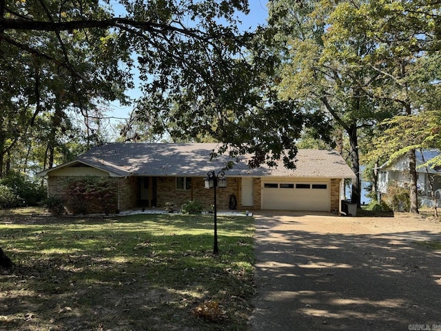 ranch-style house with a front yard and a garage