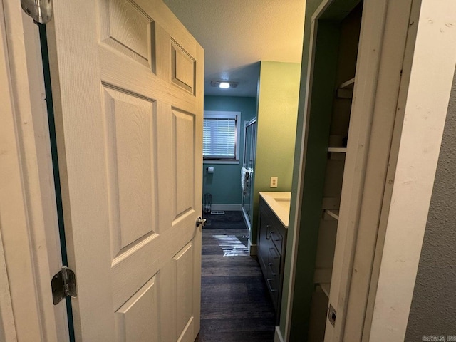 1211 S Edgewater Rd, Horseshoe Bend, AR 72512 - bathroom featuring wood finished floors, vanity, and a textured ceiling
