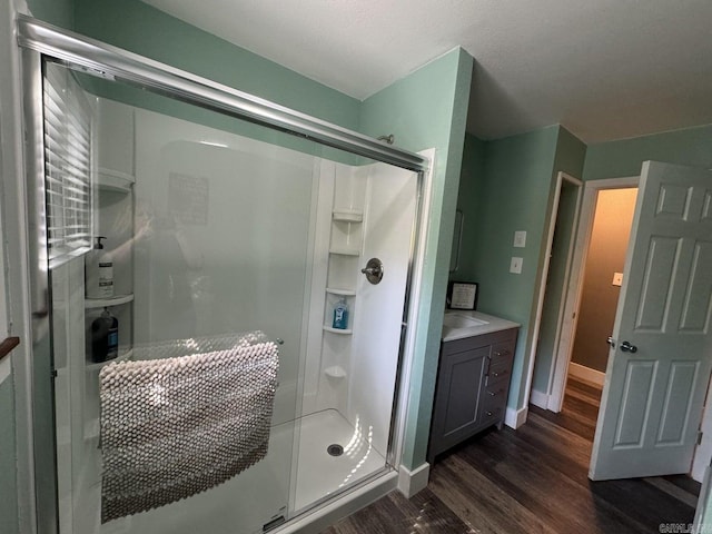 bathroom featuring vanity, wood-type flooring, and an enclosed shower