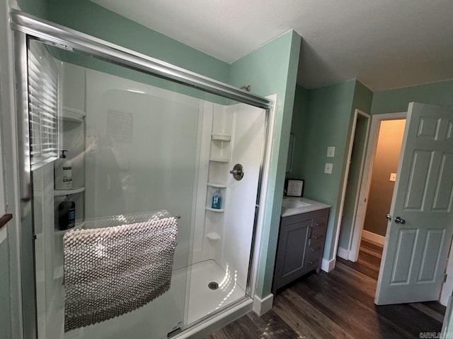 1211 S Edgewater Rd, Horseshoe Bend, AR 72512 - full bathroom featuring wood finished floors, a stall shower, and vanity
