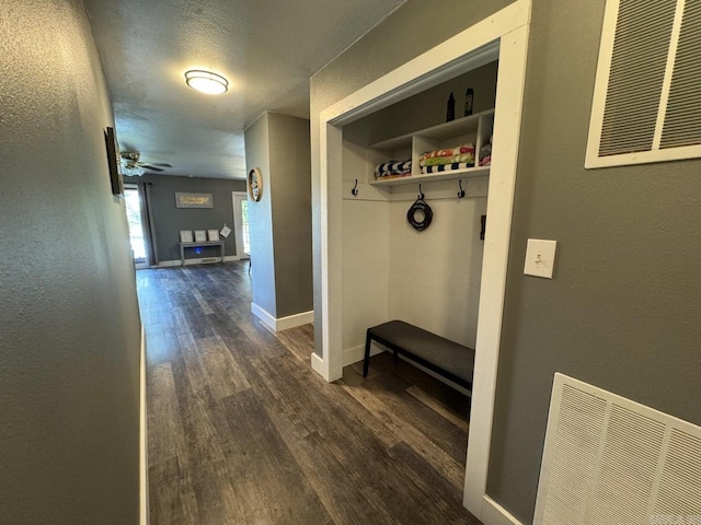 mudroom featuring a textured ceiling, dark hardwood / wood-style floors, and ceiling fan