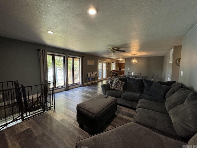 living room featuring hardwood / wood-style floors, a textured ceiling, and ceiling fan