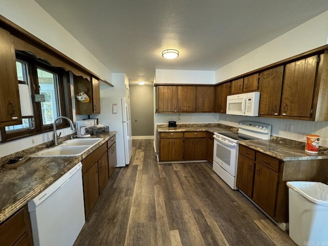 kitchen featuring dark hardwood / wood-style floors, backsplash, sink, a textured ceiling, and white appliances