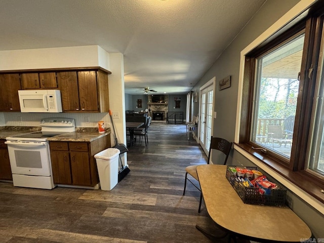 kitchen featuring ceiling fan, backsplash, a textured ceiling, dark wood-type flooring, and white appliances