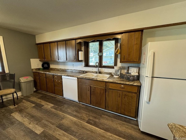 kitchen with decorative backsplash, dark hardwood / wood-style floors, sink, and white appliances