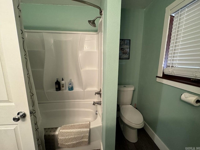 bathroom with toilet and shower / bath combination