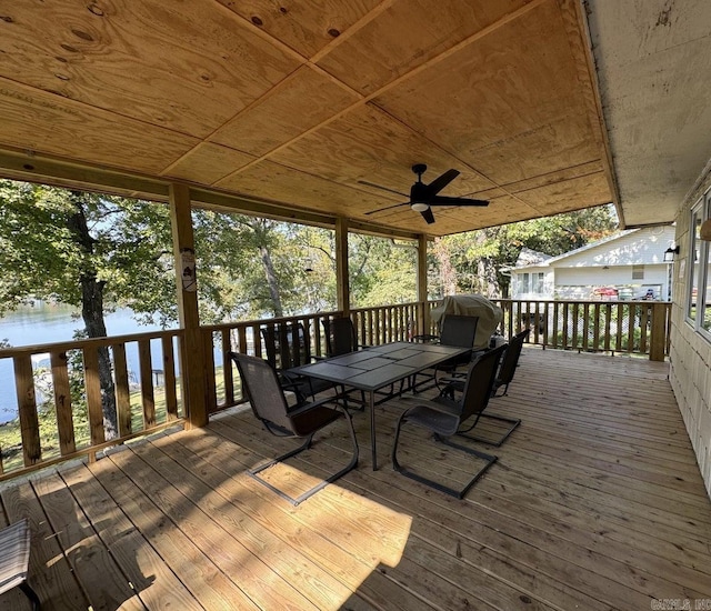 wooden deck featuring a water view and ceiling fan