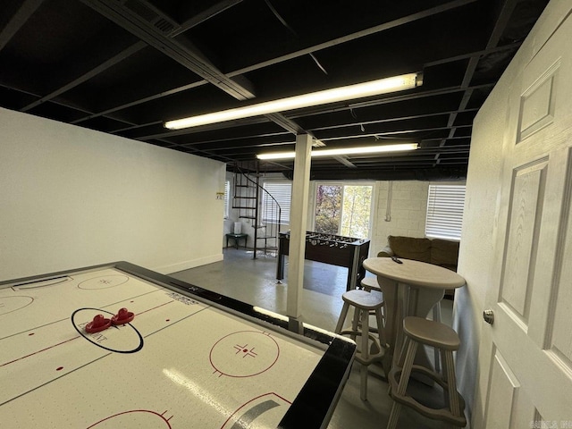 recreation room featuring concrete flooring