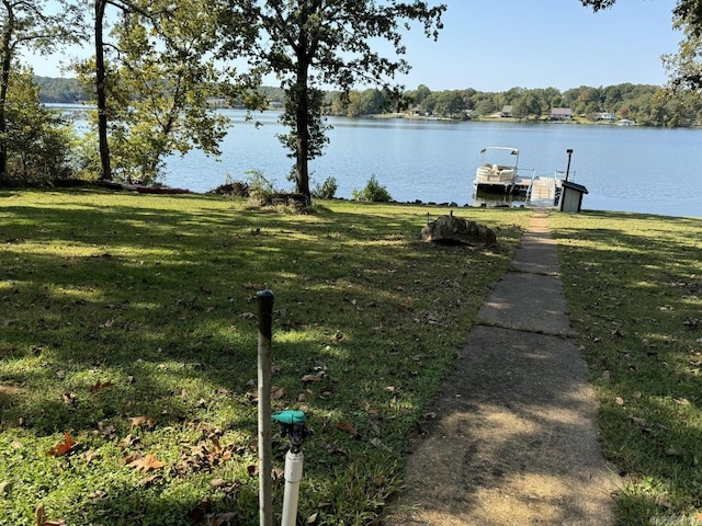 dock area with a water view and a lawn