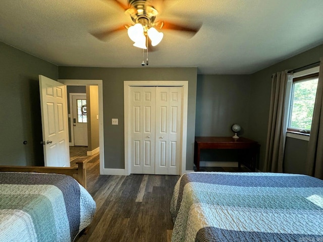 bedroom featuring a closet, dark hardwood / wood-style floors, a textured ceiling, and ceiling fan