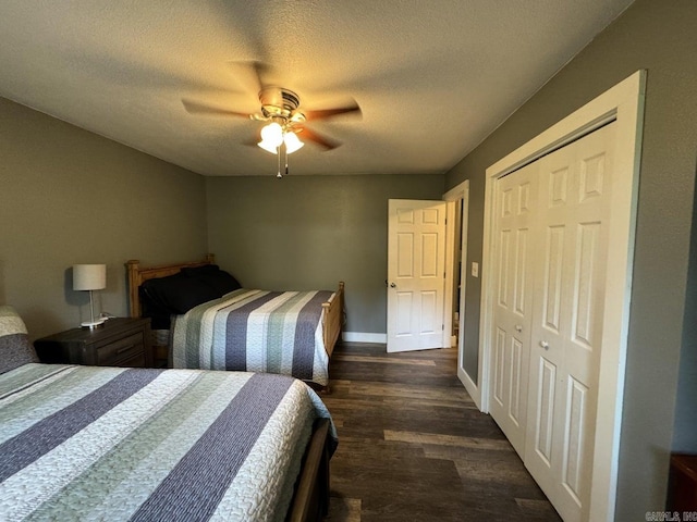 bedroom featuring dark hardwood / wood-style flooring, a textured ceiling, a closet, and ceiling fan