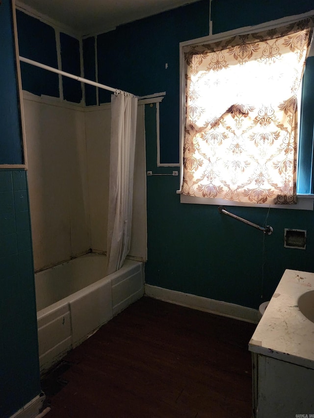 bathroom featuring vanity, hardwood / wood-style flooring, and shower / bathtub combination with curtain