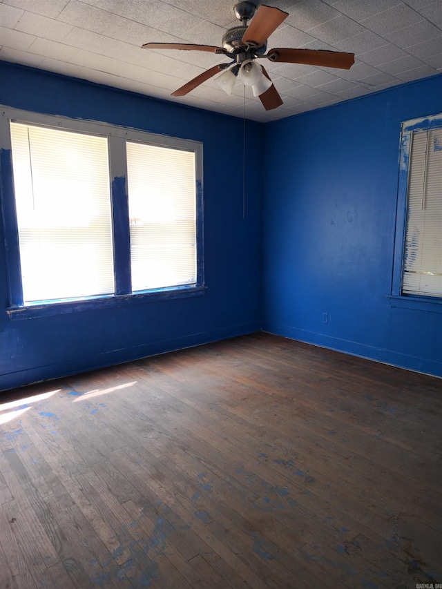 spare room with ceiling fan and dark hardwood / wood-style floors